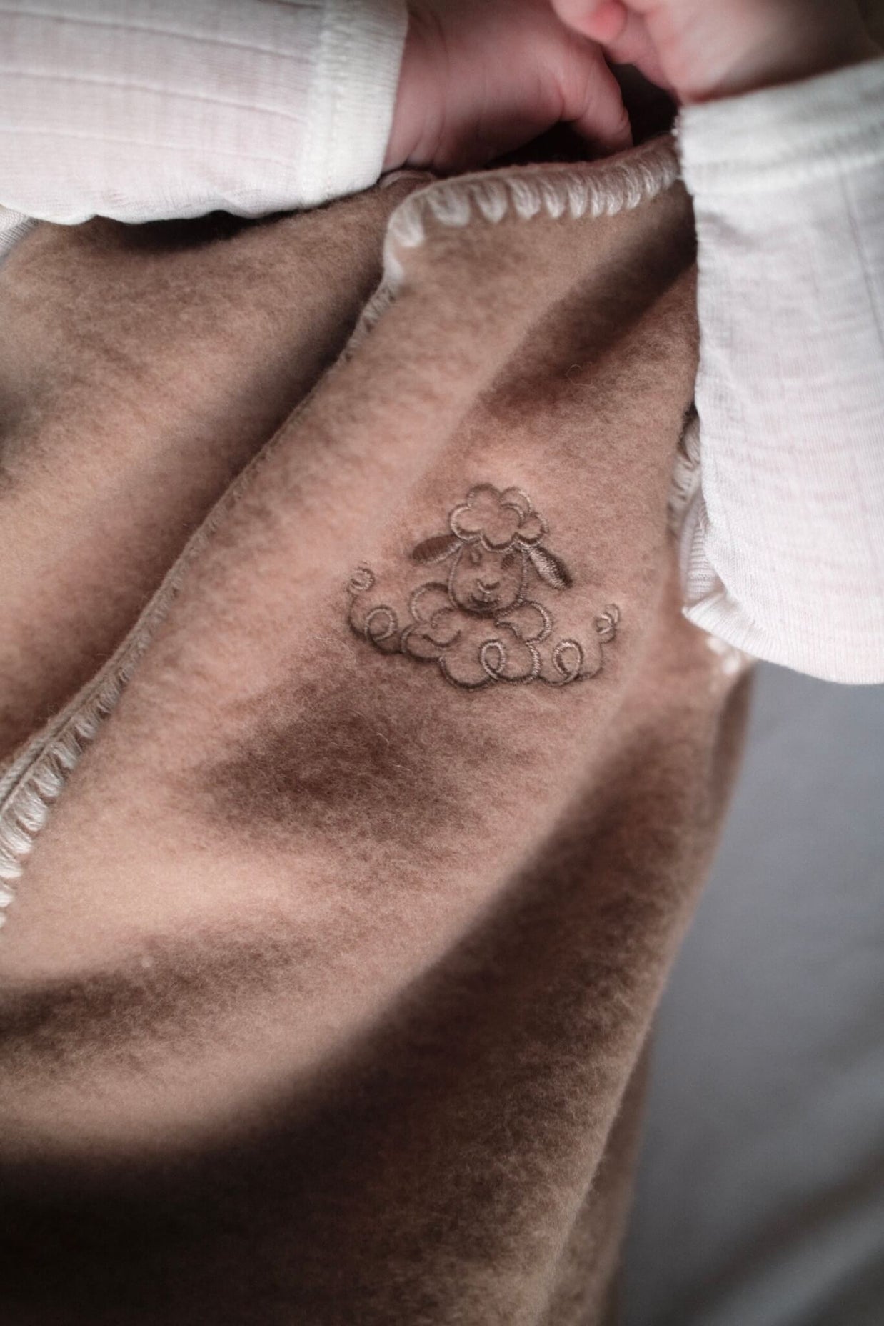 Geborduurde Merino wollen slaapzak newborn