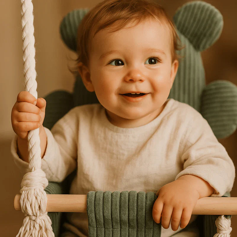 Lachende baby zittend in MeowBaby Indoor Baby Schommel Beer groen met zachte bekleding.